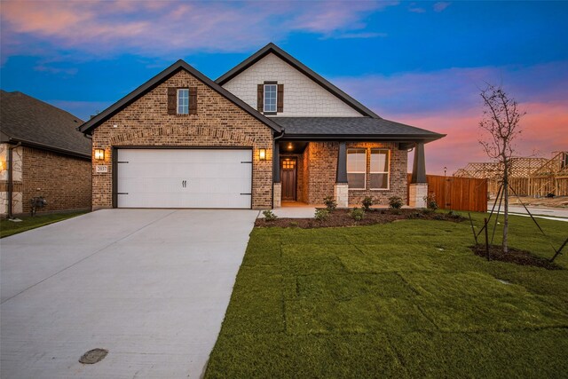 view of front of house with a yard and a garage