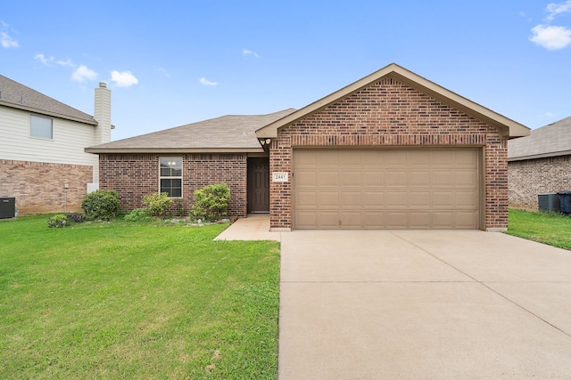 view of front of house featuring a garage, cooling unit, and a front yard