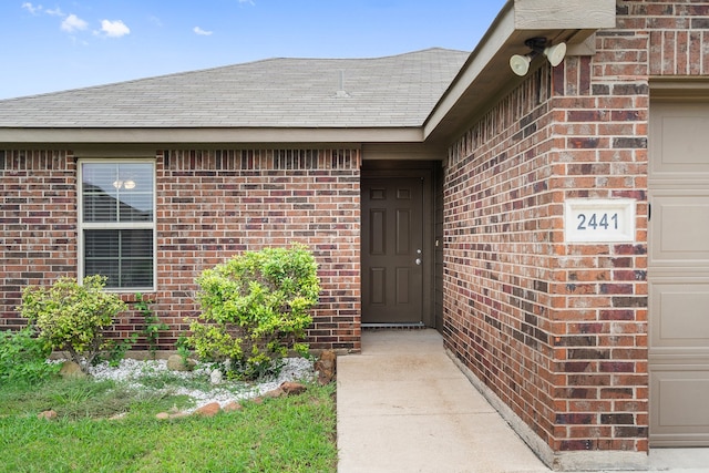 view of exterior entry with a garage