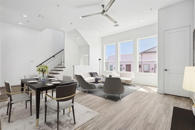 dining space featuring light wood finished floors, visible vents, ceiling fan, stairway, and recessed lighting