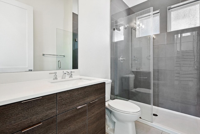 bathroom featuring vanity, toilet, and walk in shower