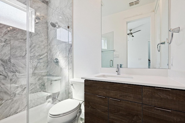 full bath with toilet, vanity, visible vents, and a shower stall