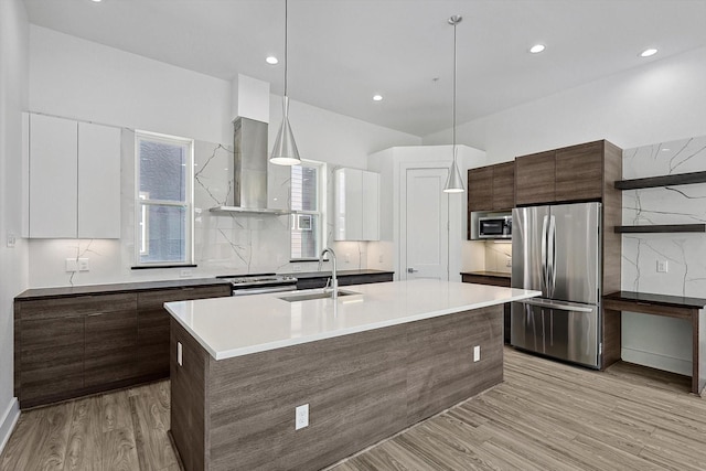 kitchen featuring white cabinets, sink, stainless steel appliances, and hanging light fixtures