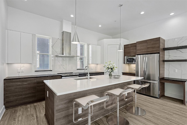 kitchen featuring appliances with stainless steel finishes, pendant lighting, white cabinetry, and modern cabinets