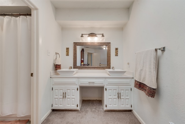 bathroom featuring curtained shower and vanity