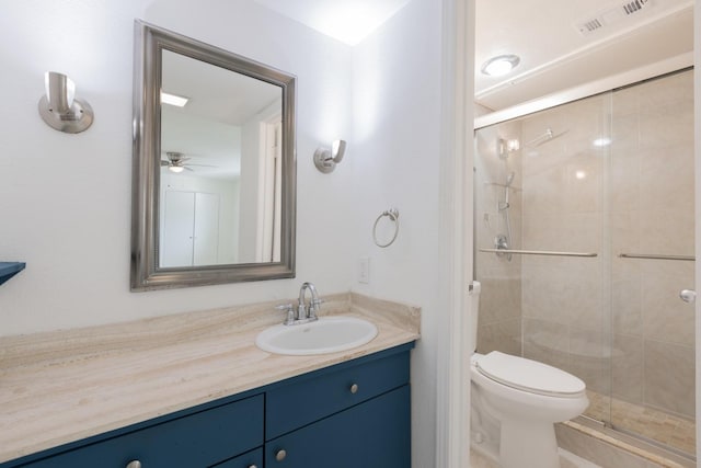 bathroom featuring vanity, ceiling fan, toilet, and walk in shower