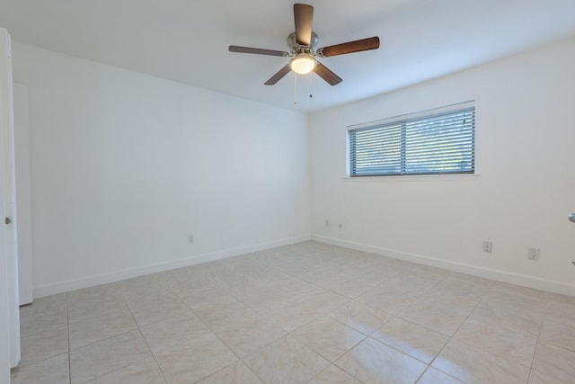 spare room featuring ceiling fan and light tile patterned flooring