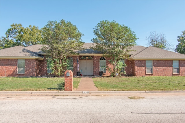 ranch-style home with a front lawn