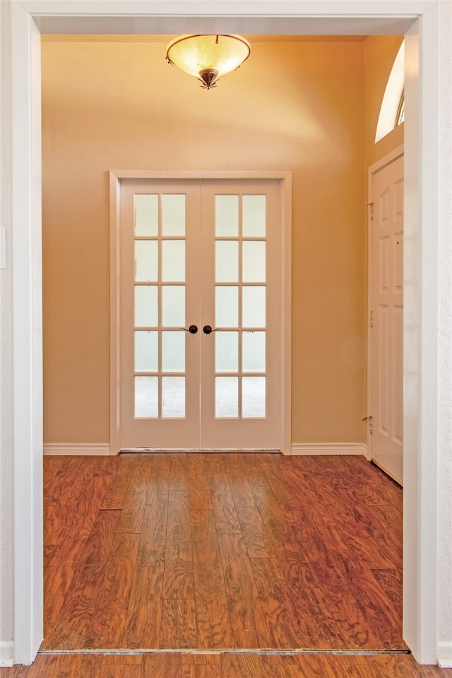 entryway with hardwood / wood-style flooring and french doors