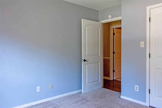 unfurnished bedroom featuring light colored carpet