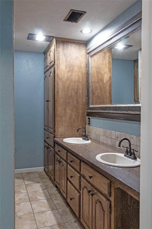 bathroom featuring vanity, tasteful backsplash, and tile patterned floors