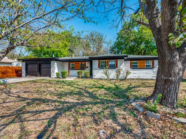 ranch-style home with a front yard and a garage