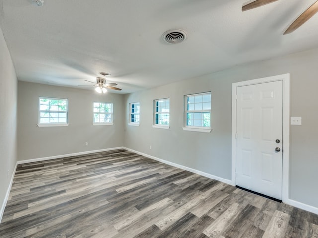 spare room with dark hardwood / wood-style floors, a textured ceiling, and ceiling fan