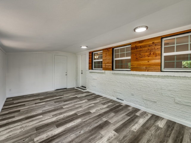 interior space featuring vaulted ceiling and dark hardwood / wood-style flooring