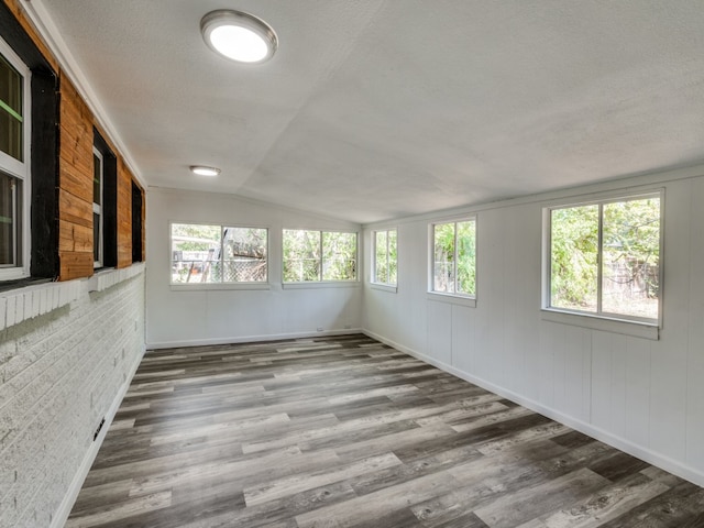 unfurnished sunroom with lofted ceiling and plenty of natural light