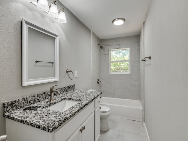 full bathroom with tiled shower / bath, vanity, and toilet