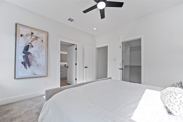 bedroom featuring ceiling fan, carpet flooring, a closet, a spacious closet, and ensuite bathroom