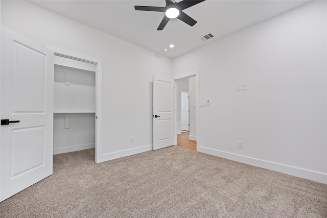 unfurnished bedroom with ceiling fan, carpet floors, and a closet