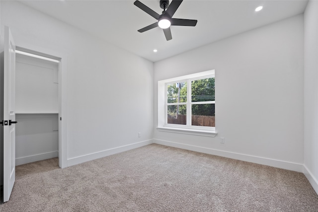 unfurnished bedroom featuring ceiling fan, carpet floors, and a closet