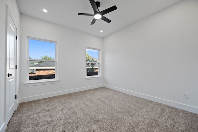 carpeted empty room featuring ceiling fan