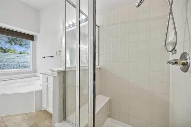 bathroom featuring a garden tub and a stall shower