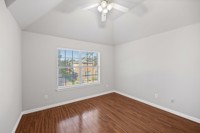 spare room featuring vaulted ceiling, a ceiling fan, baseboards, and dark wood-style flooring