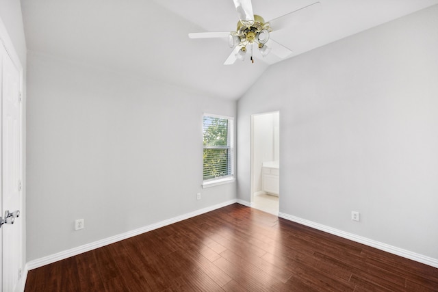 unfurnished bedroom featuring wood finished floors, baseboards, ensuite bath, lofted ceiling, and ceiling fan