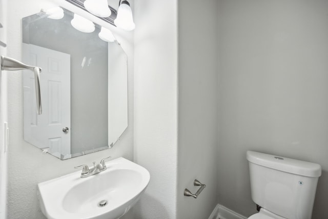 bathroom with toilet and a sink