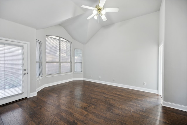 unfurnished room featuring lofted ceiling, dark wood-type flooring, a healthy amount of sunlight, and a ceiling fan