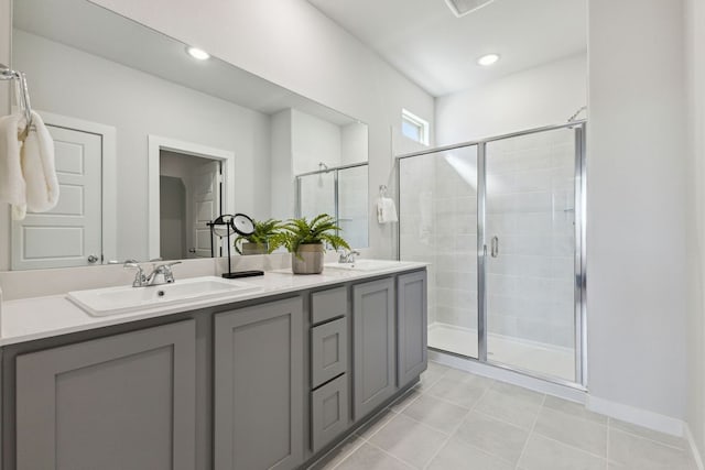 bathroom with tile patterned flooring, walk in shower, and vanity