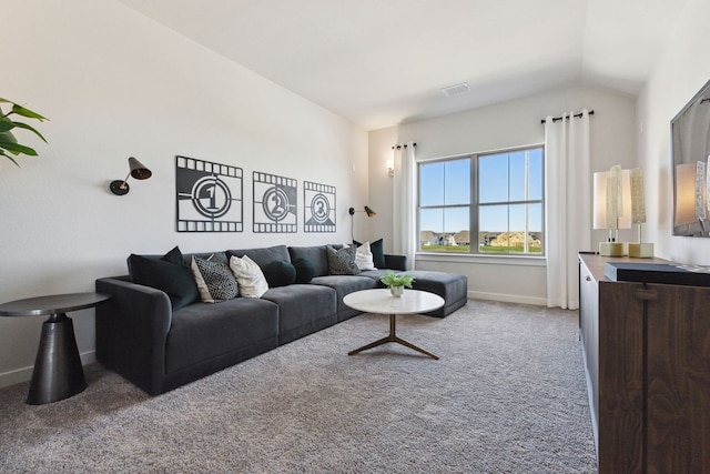 carpeted living room with lofted ceiling