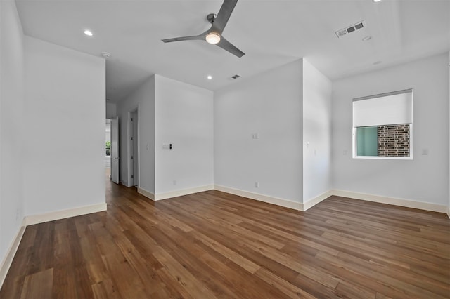 empty room featuring ceiling fan and dark hardwood / wood-style flooring