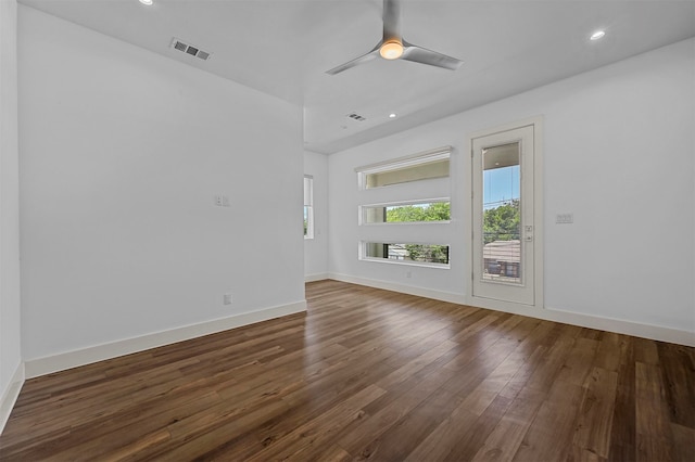 unfurnished living room with ceiling fan and dark hardwood / wood-style flooring