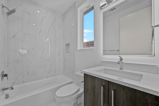 full bathroom with toilet, vanity, and tiled shower / bath combo