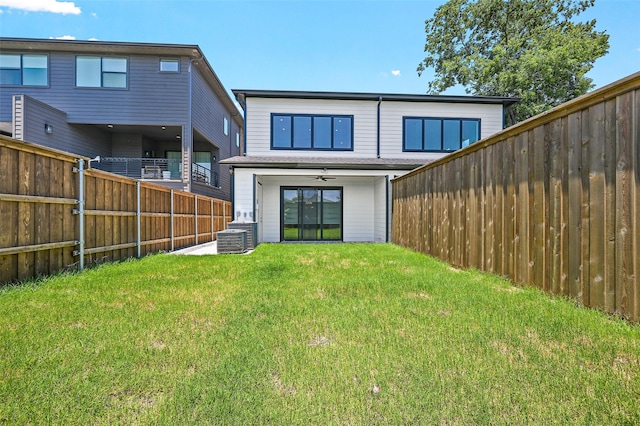 rear view of house with a yard, ceiling fan, and a patio area