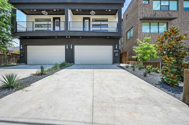 contemporary home with a garage and a balcony