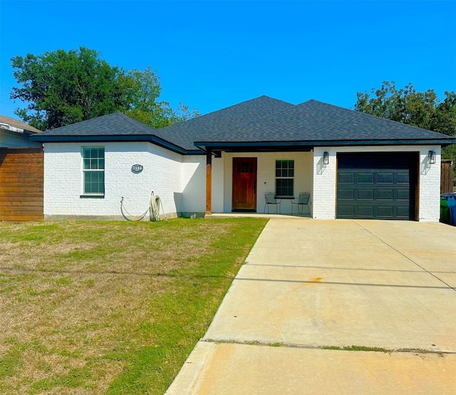 view of front facade featuring a garage and a front lawn