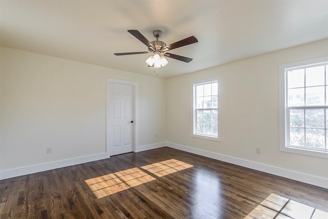 unfurnished room featuring ceiling fan, a wealth of natural light, and dark hardwood / wood-style floors