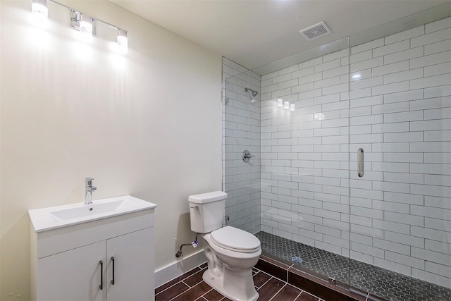 bathroom with vanity, toilet, and an enclosed shower