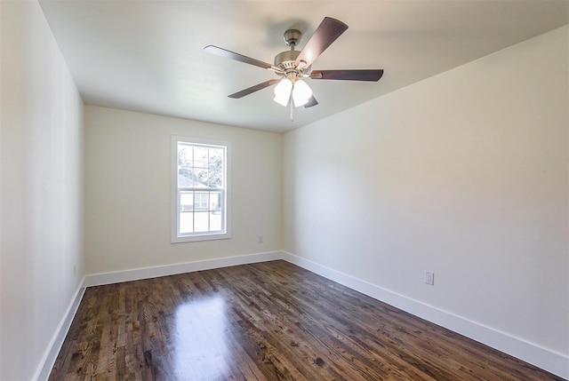 spare room with ceiling fan and dark wood-type flooring