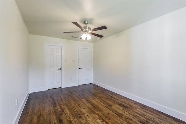 unfurnished bedroom featuring dark wood-type flooring and ceiling fan