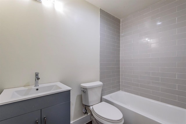 full bathroom with tiled shower / bath, vanity, and toilet