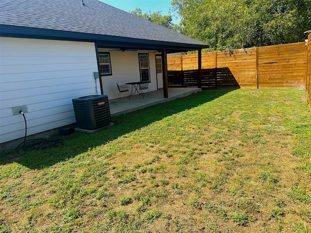 view of yard featuring central AC unit and a patio area