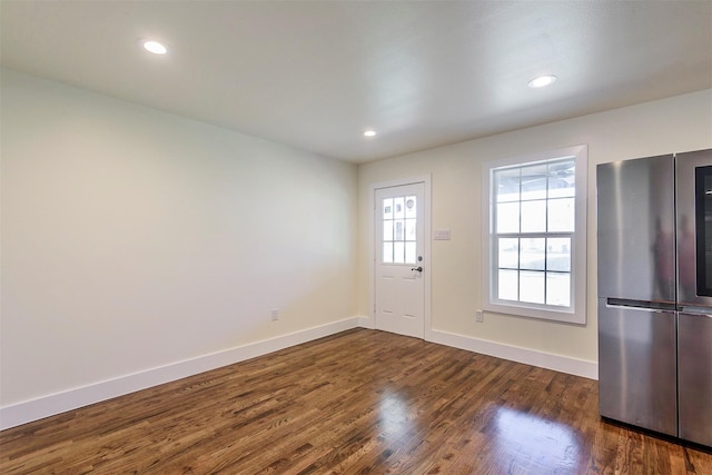 entryway with dark hardwood / wood-style flooring