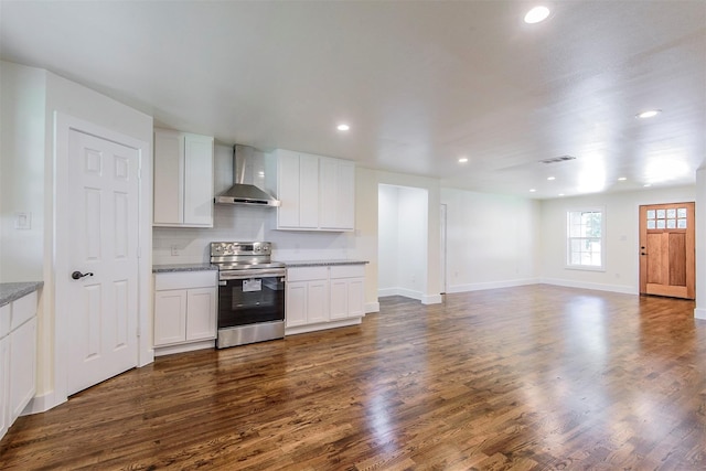 kitchen featuring wall chimney range hood, dark hardwood / wood-style flooring, electric range, decorative backsplash, and white cabinetry