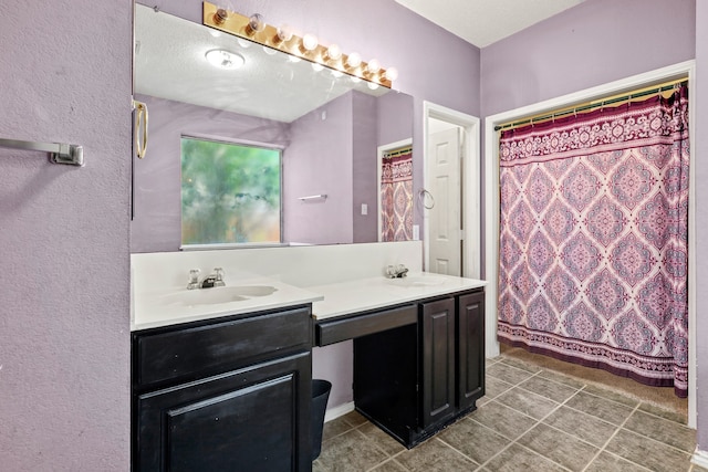 bathroom featuring tile patterned floors, a shower with shower curtain, vanity, and a textured ceiling