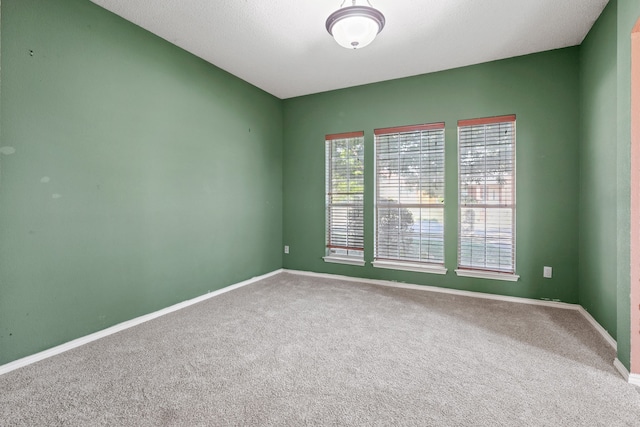 unfurnished room featuring carpet flooring