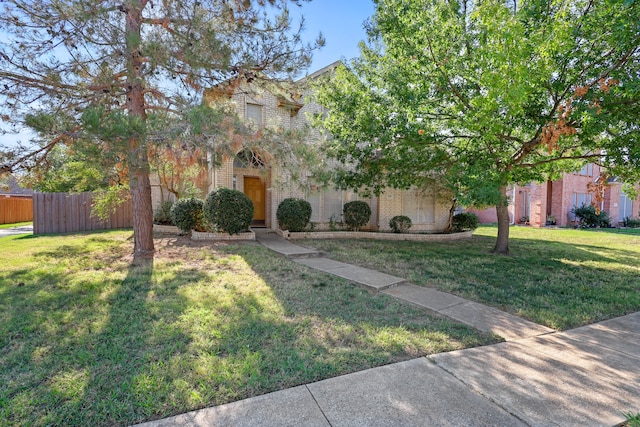 obstructed view of property with a front yard