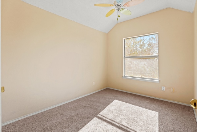 unfurnished room with ceiling fan, lofted ceiling, and carpet flooring