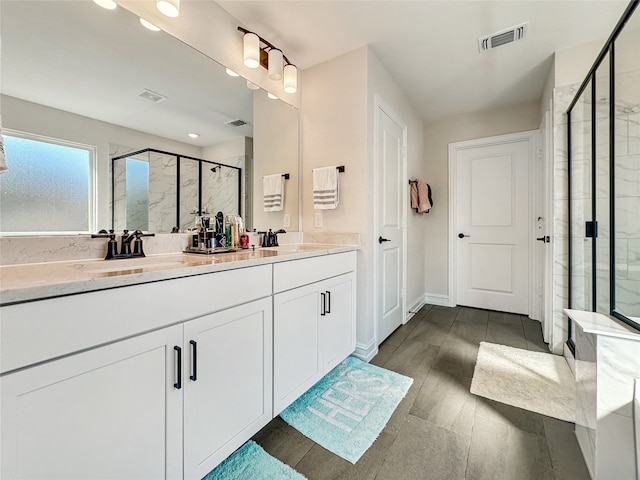 bathroom featuring vanity, hardwood / wood-style floors, and an enclosed shower